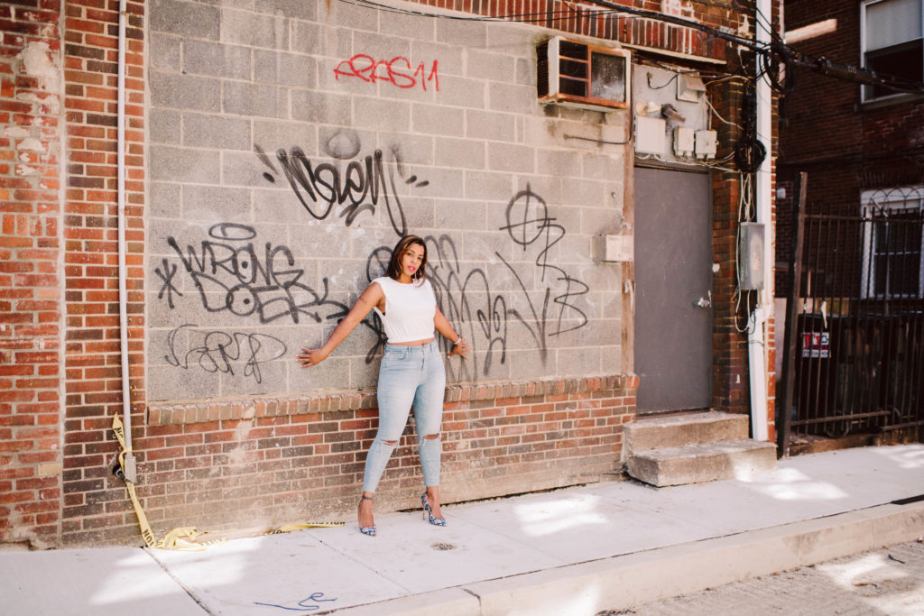 lifestyle photography of woman against graffiti
