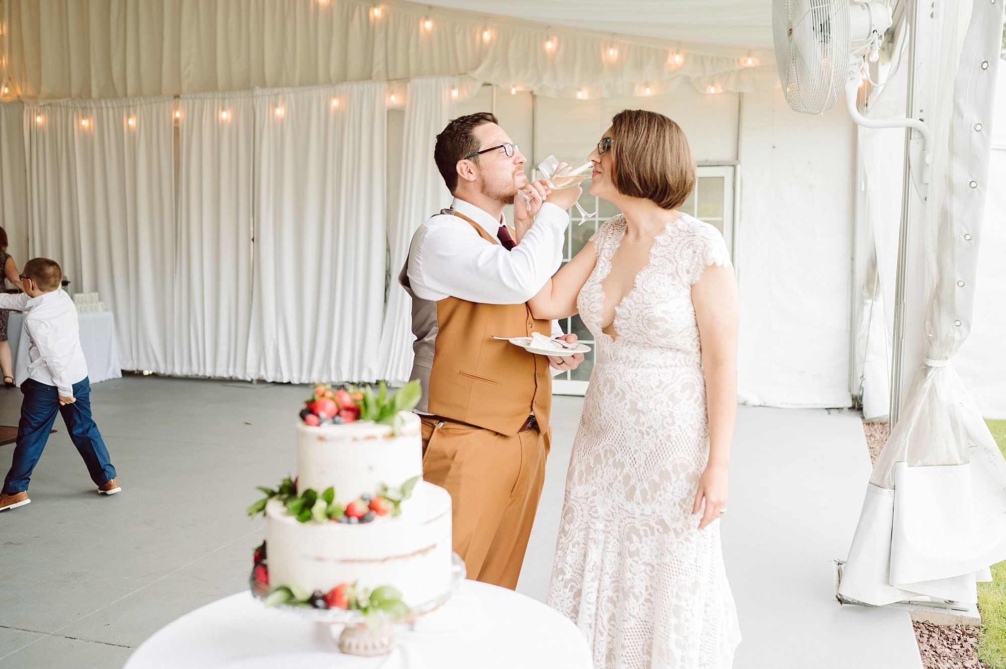 drinking wine and cake crossing vineyard wedding photographer