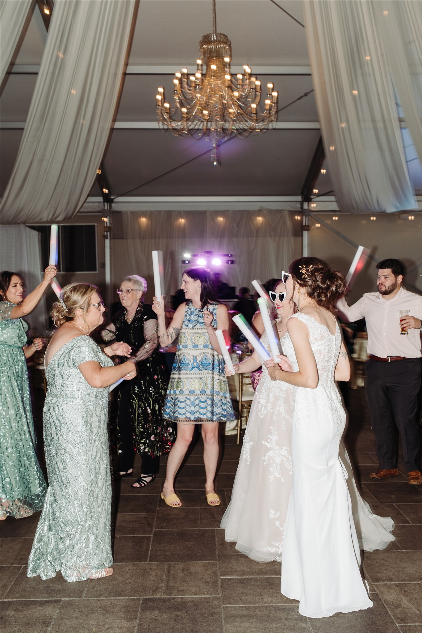 brides sharing a candid laugh on the lawn of pen ryn estate – capturing joy and love in an authentic moment.