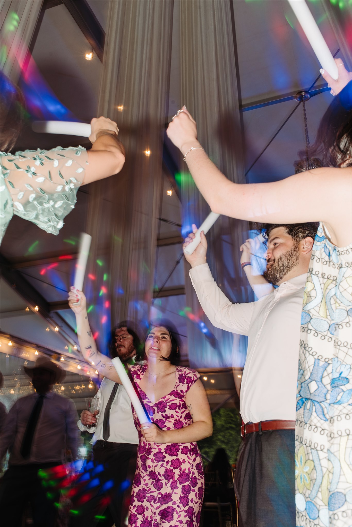 queer couple kissing beneath string lights at pen ryn estate – a soft and dreamy nighttime wedding portrait.