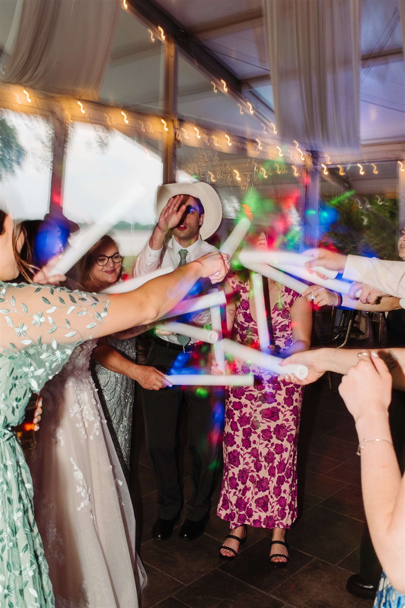 wedding guests dancing joyfully at a springtime lgbtq+ wedding – high energy and celebration on the dance floor.