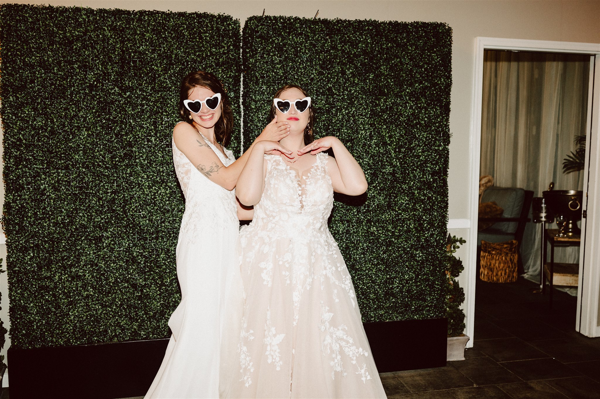 brides sneaking a quiet moment together between wedding events – a documentary-style, intimate photograph.