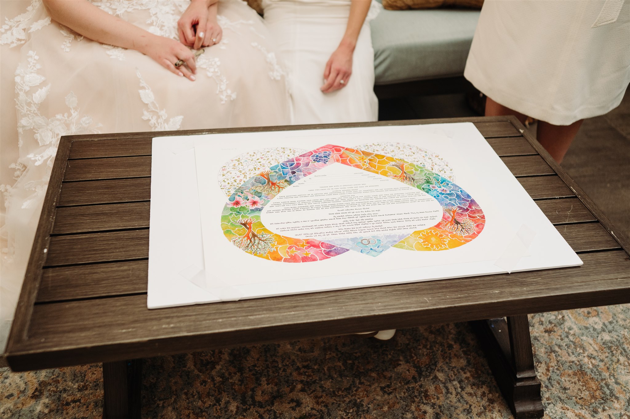 queer couple’s grand entrance into wedding reception – newlyweds beaming as they join their loved ones.