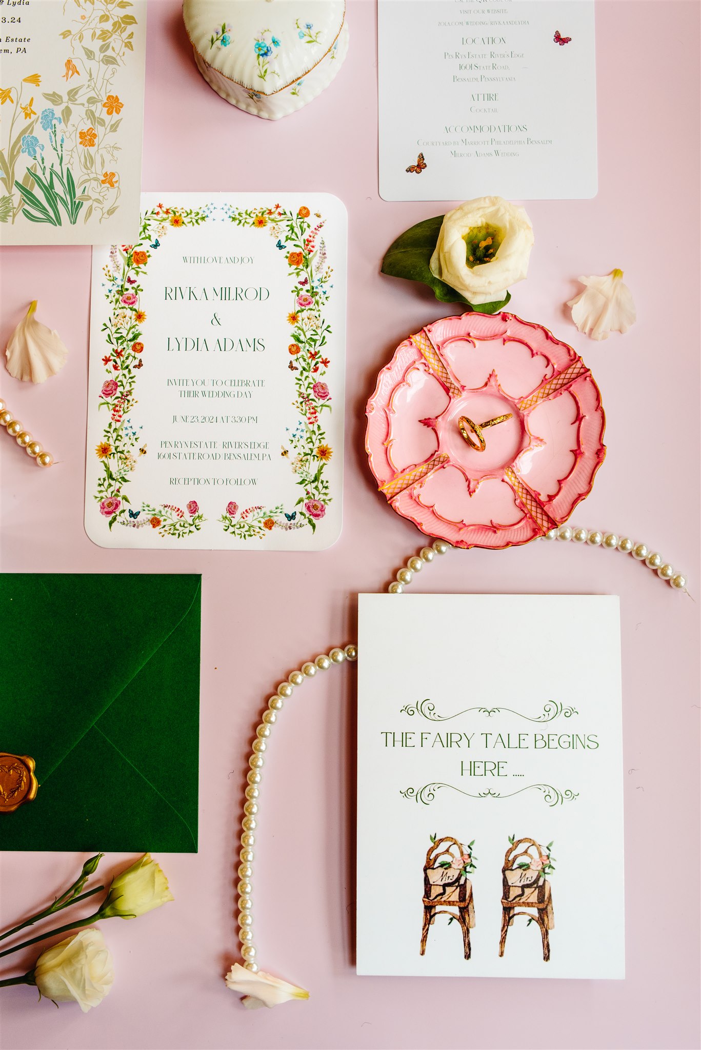 Wedding-themed items including an invitation, rings, floral box, green envelope, and flowers.