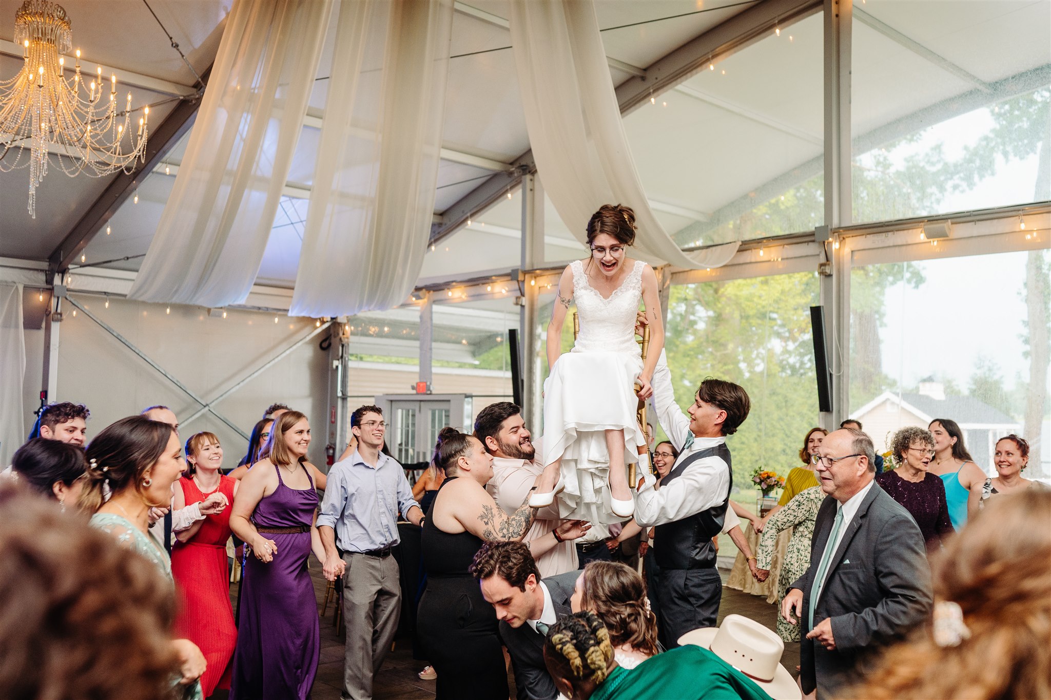 same-sex couple exchanging rings at river’s edge wedding venue – a romantic and traditional wedding moment.