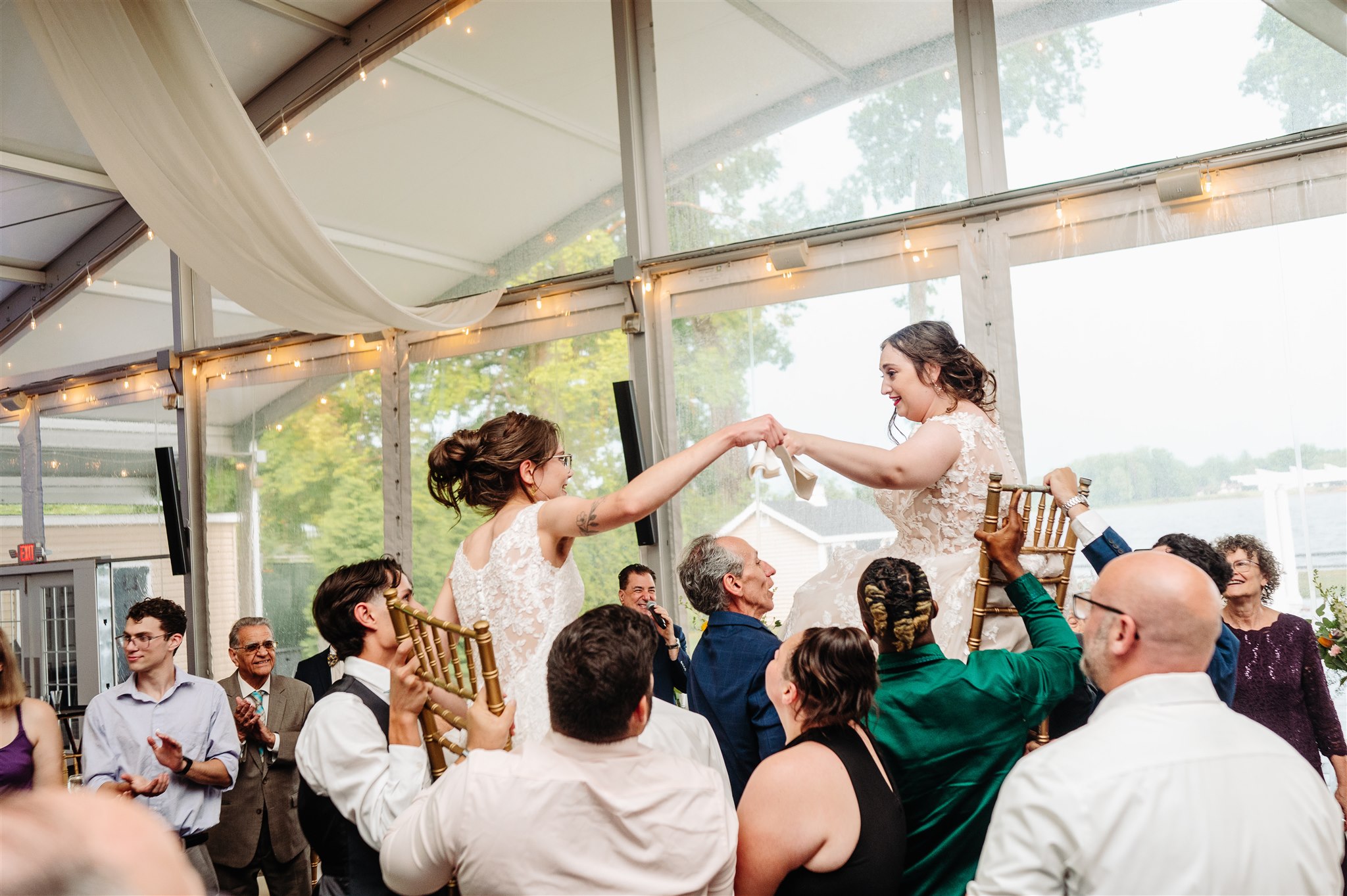 lgbtq+ brides adjusting each other’s attire before the ceremony – intimate and romantic detail shot.