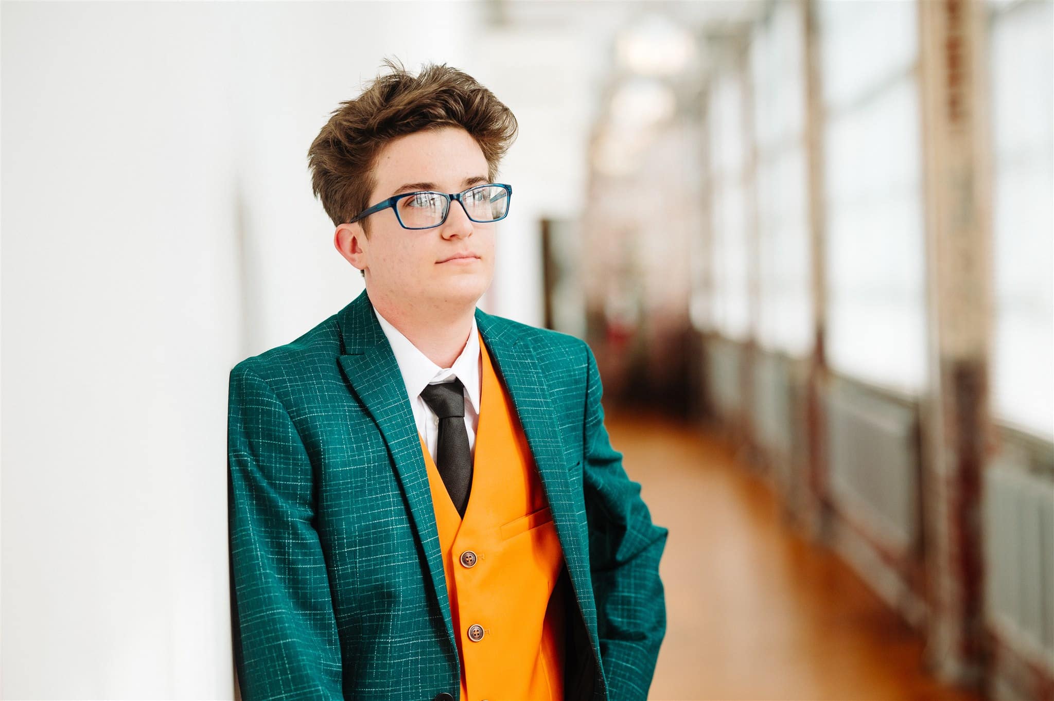 queer couple twirling on the dance floor at their wedding reception – movement, joy, and love in one frame.