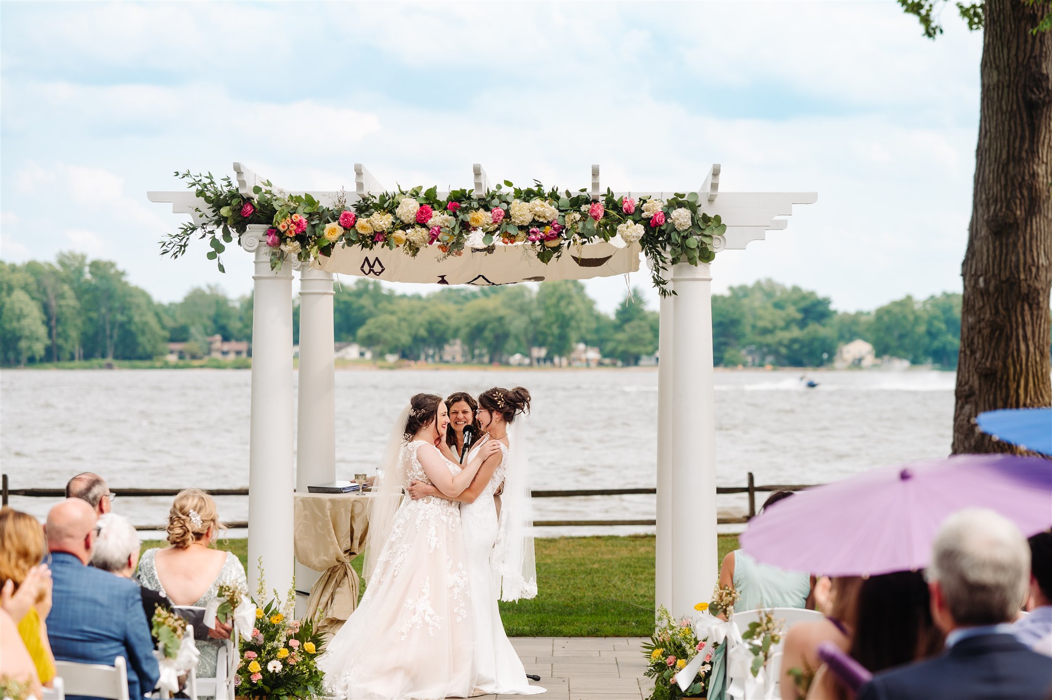 fine art wedding portrait of a lgbtq+ couple at river’s edge – elegant and timeless wedding photography.