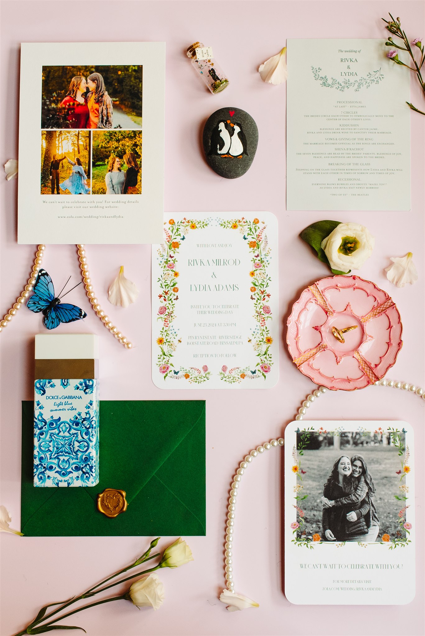 Wedding invitation suite with cards, green envelope, perfume box, pearls, flowers, and decorative items.