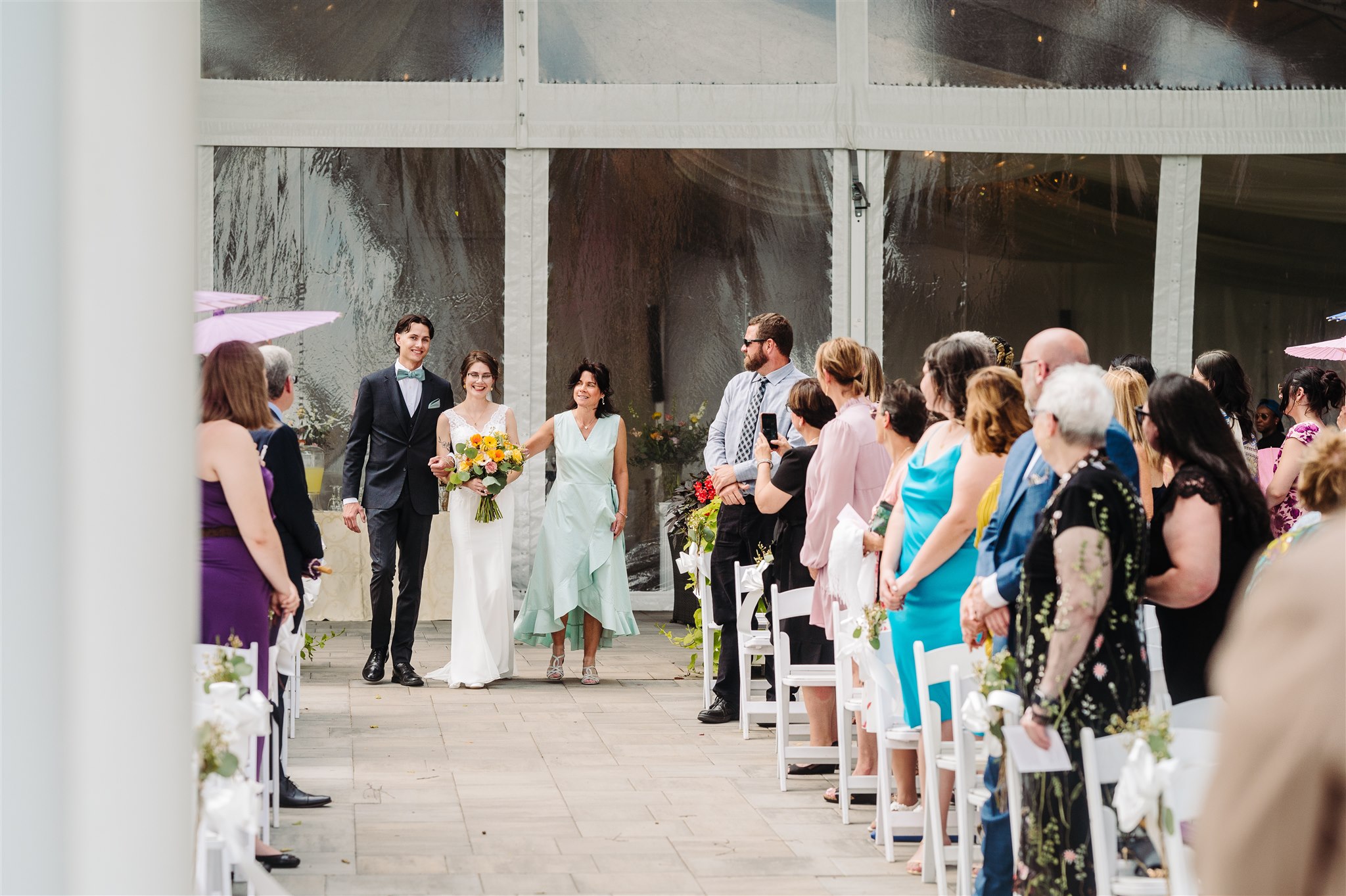 first kiss as newlyweds at river’s edge wedding venue – a magical moment as the couple seals their love.