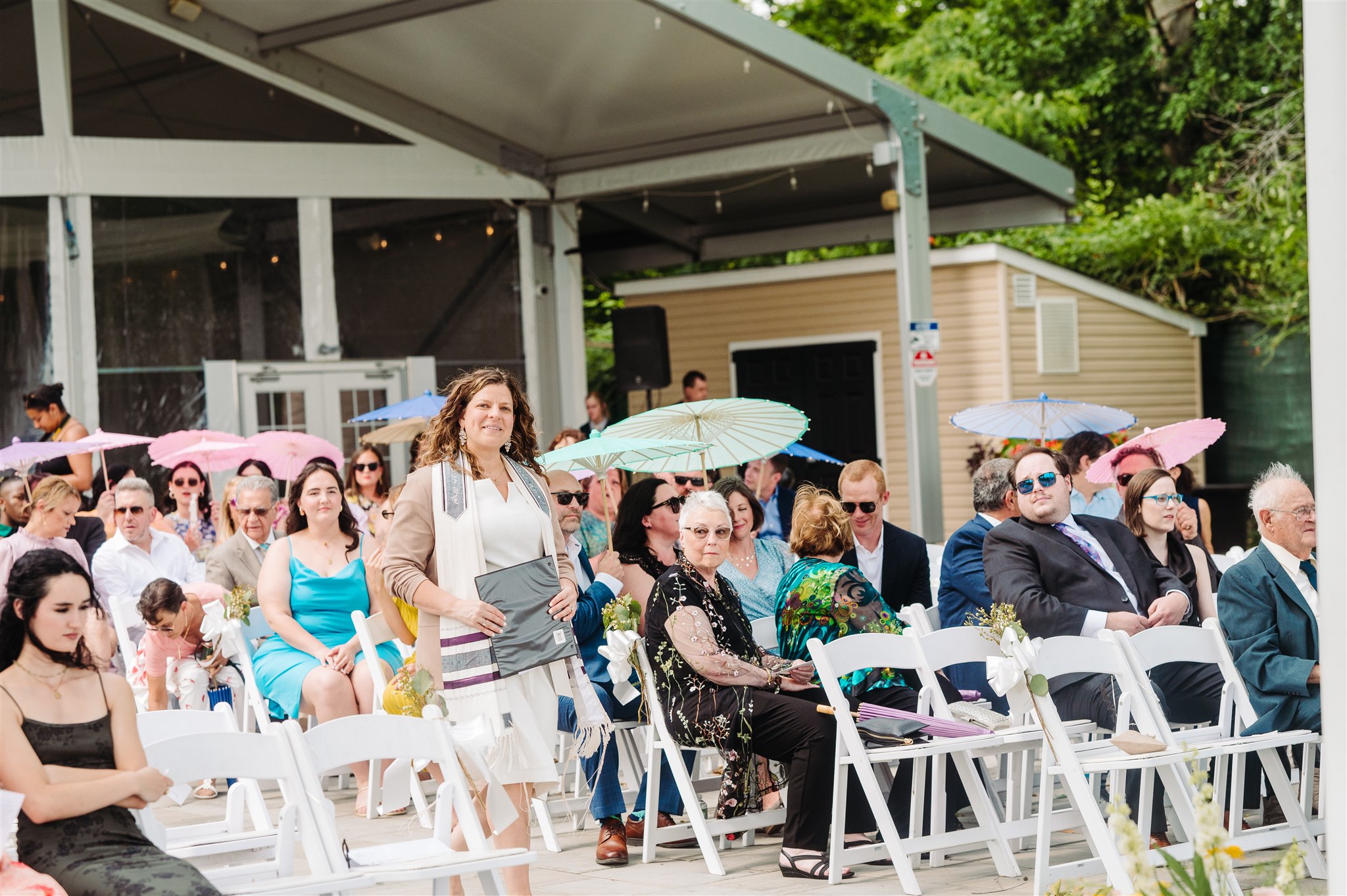 wedding guests cheering after the chuppah ceremony – a joyful reaction to a beautiful union.