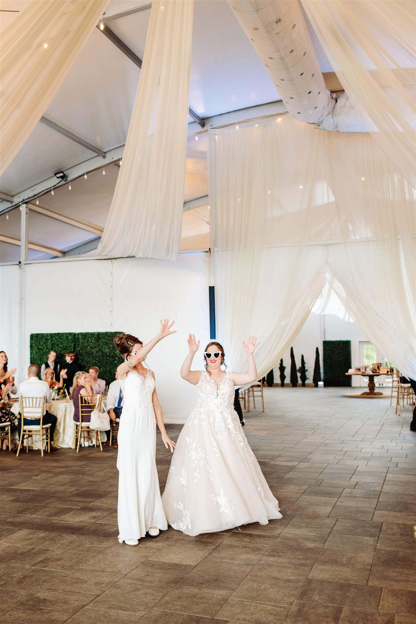 brides' wedding dresses flowing in the wind at pen ryn estate – a dreamy, cinematic moment.