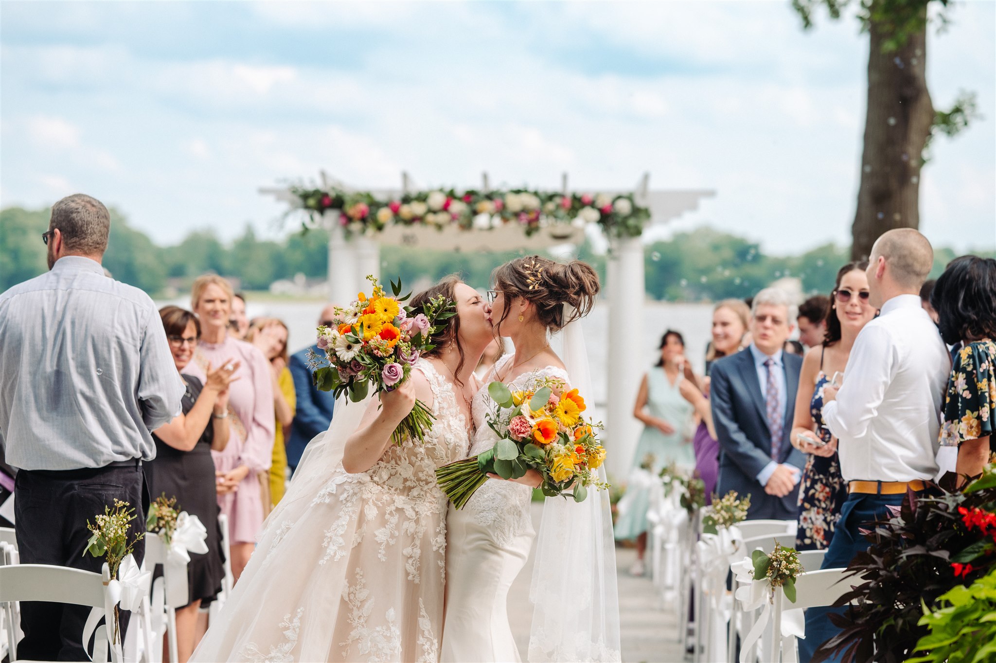 brides sharing first kiss as married couple: a tender moment sealing their vows.