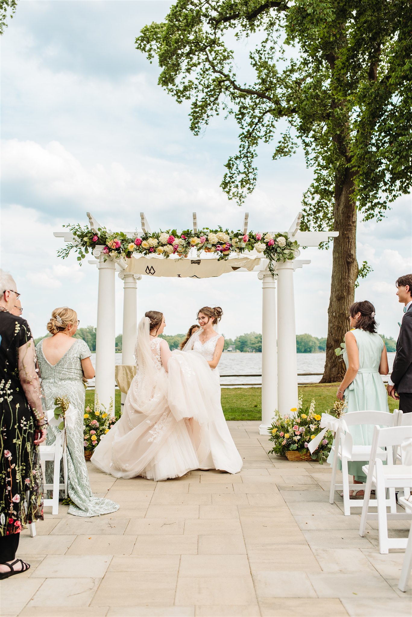 brides exchanging vows under the chuppah at pen ryn estate – heartfelt moments as the couple speaks their promises.