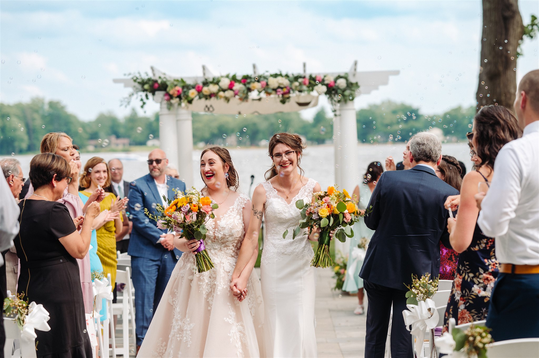 emotional exchange of vows between two brides: partners gazing into each other's eyes, expressing their love.