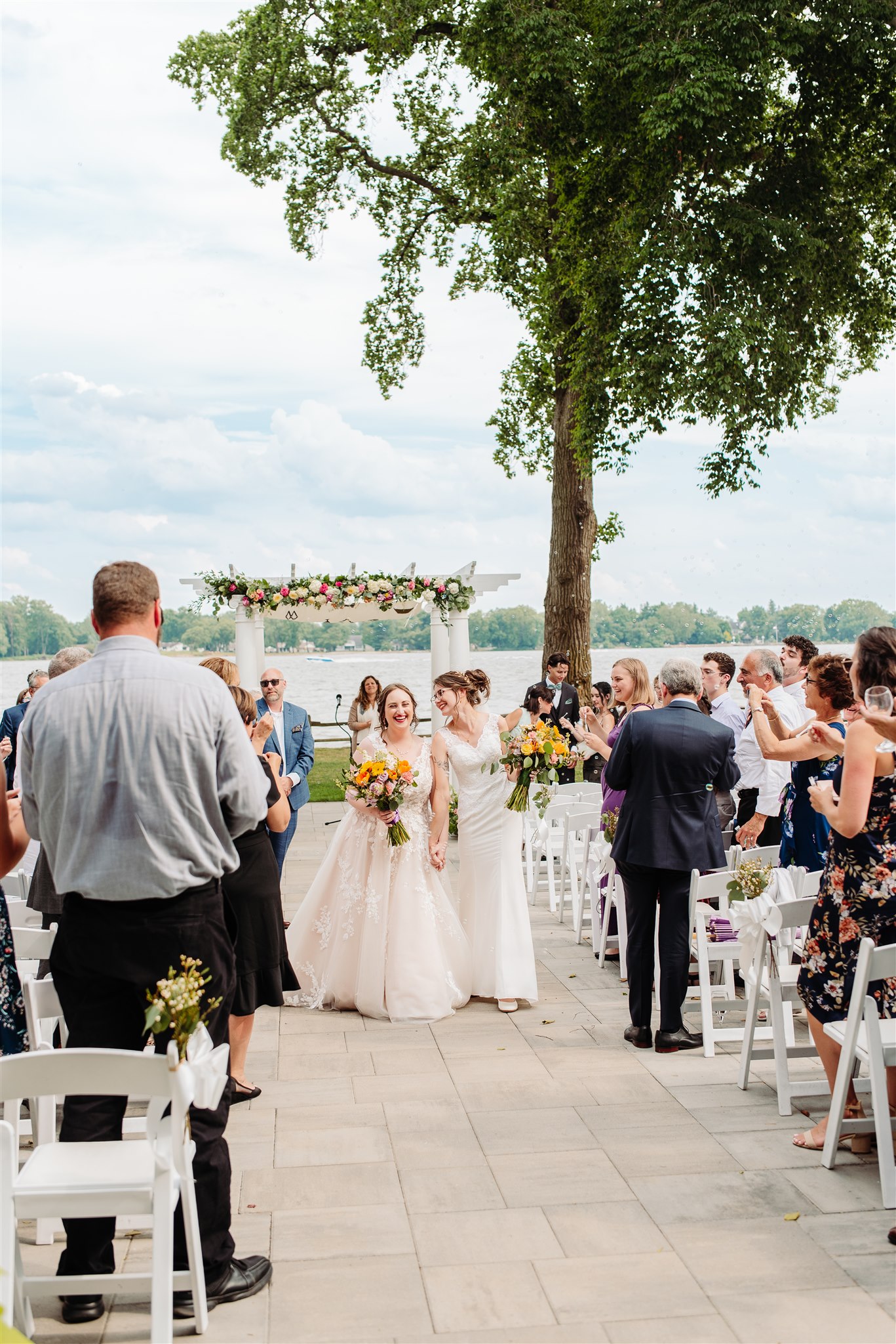 guests showering couple with rose petals post-ceremony: a celebratory exit filled with love and color.