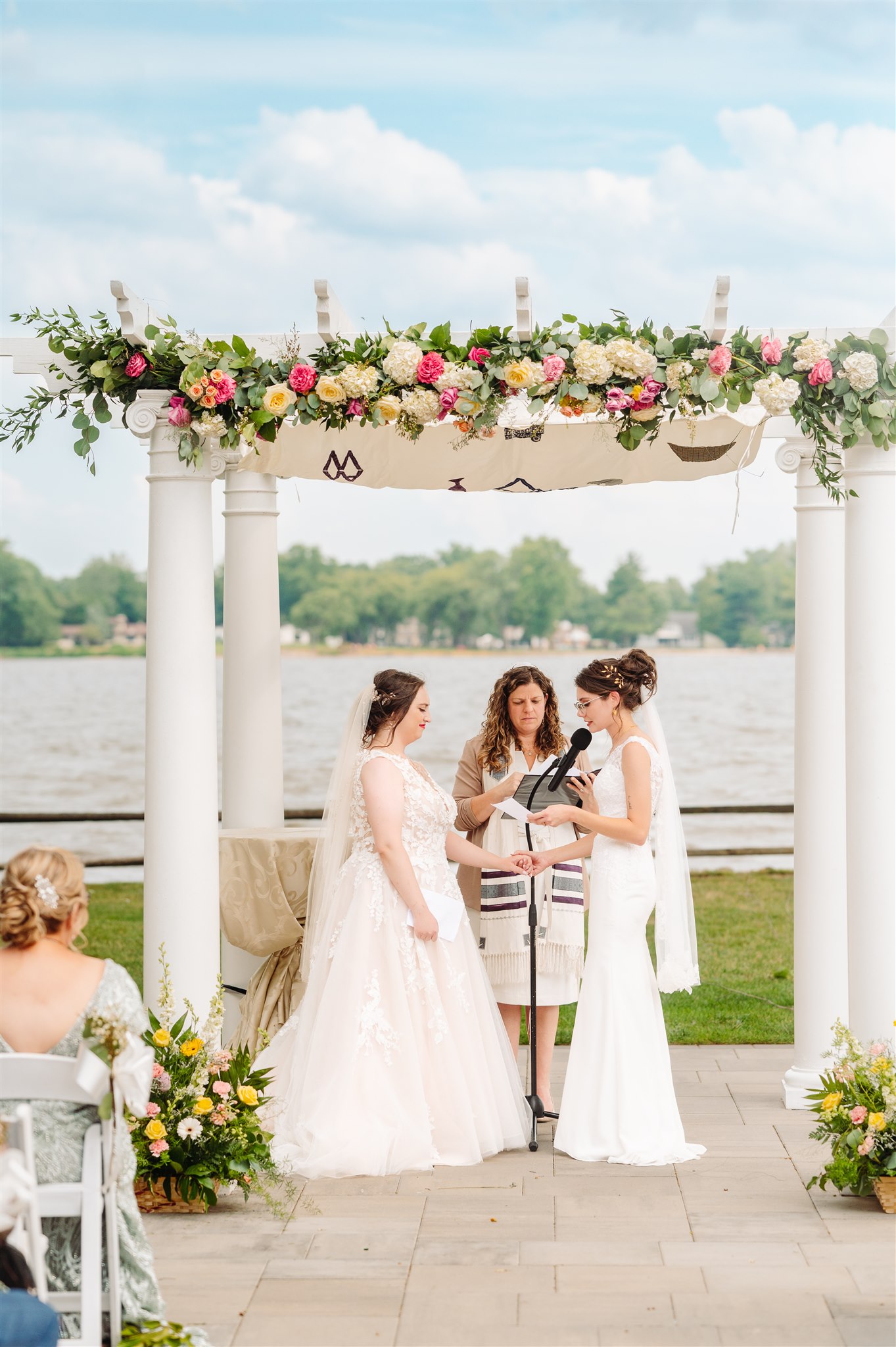 parents blessing brides under chuppah: a touching family moment honoring tradition.